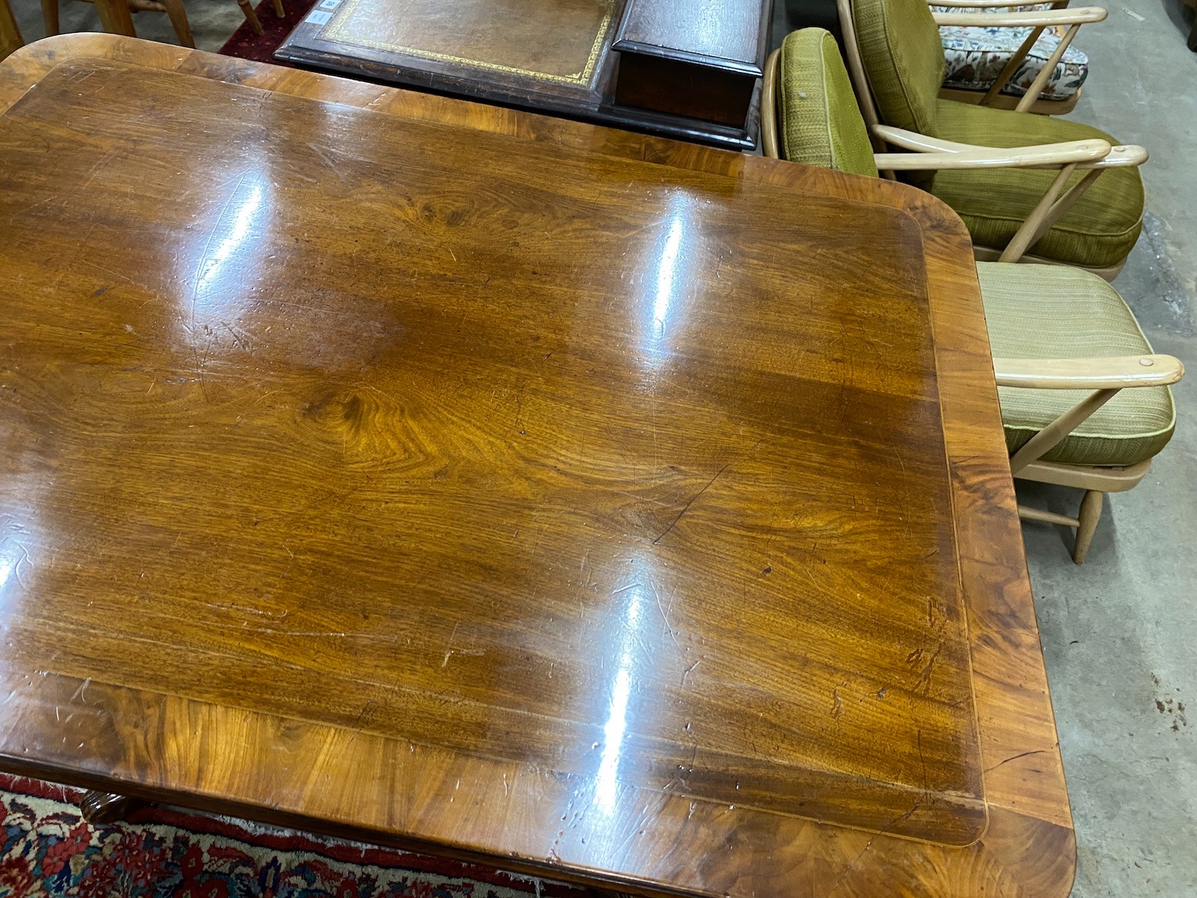 A Regency banded mahogany rectangular tilt top dining table, length 141cm, depth 106cm, height 75cm